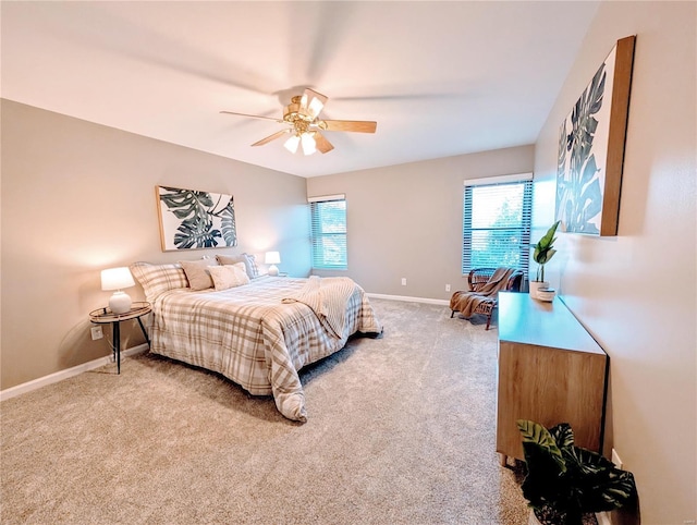 carpeted bedroom featuring multiple windows and ceiling fan