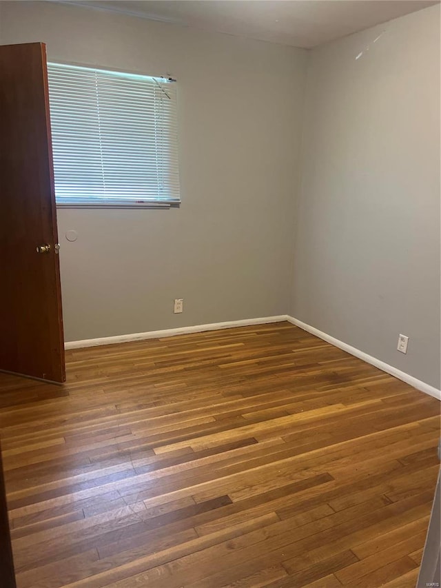 unfurnished room featuring dark hardwood / wood-style floors