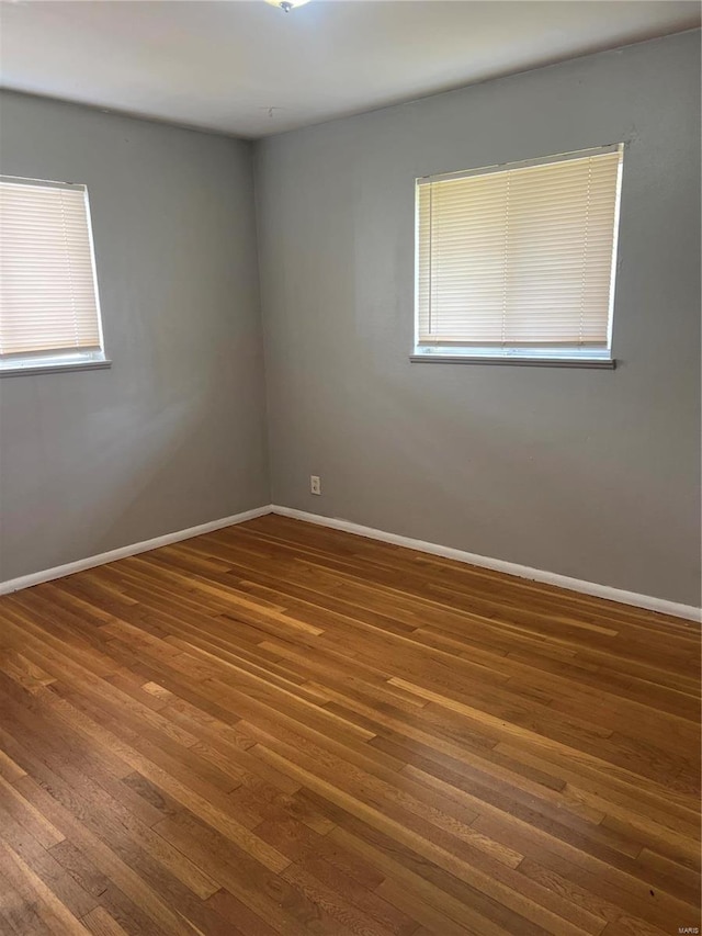 spare room featuring dark wood-type flooring