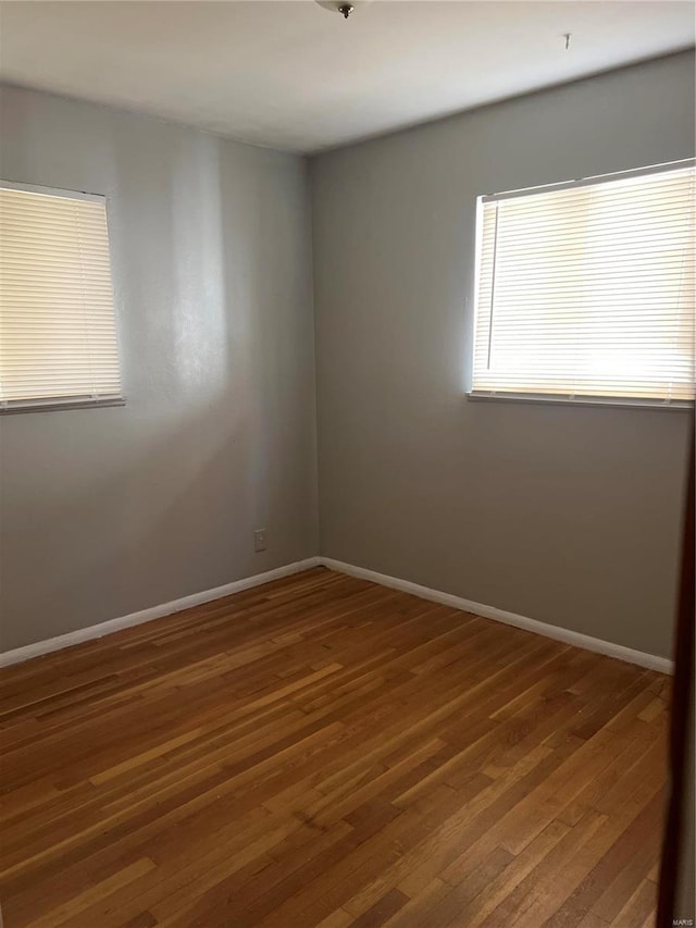 spare room with dark hardwood / wood-style floors