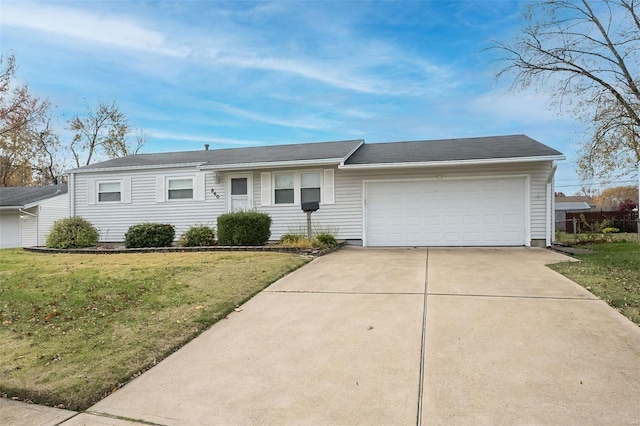 ranch-style home featuring a garage and a front lawn