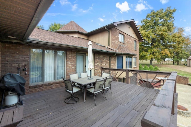 wooden terrace with a grill