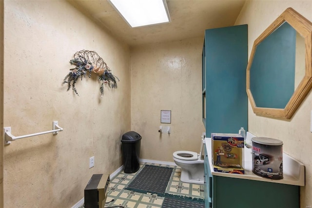 half bath with toilet and tile patterned floors