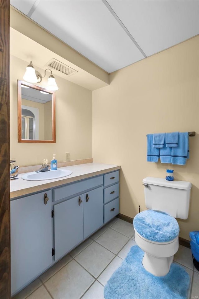 bathroom with vanity, toilet, and tile patterned flooring