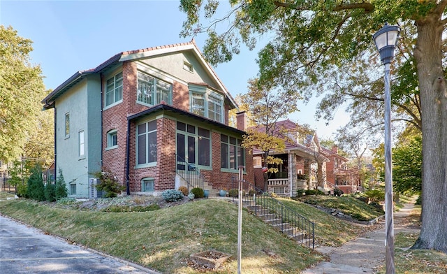 view of front facade featuring a sunroom and a front yard