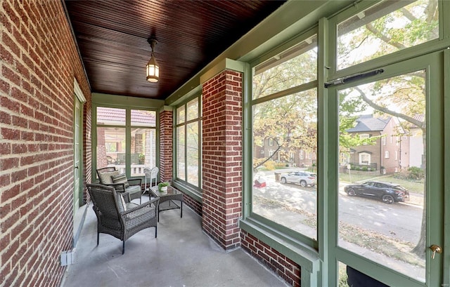 sunroom with wooden ceiling and plenty of natural light