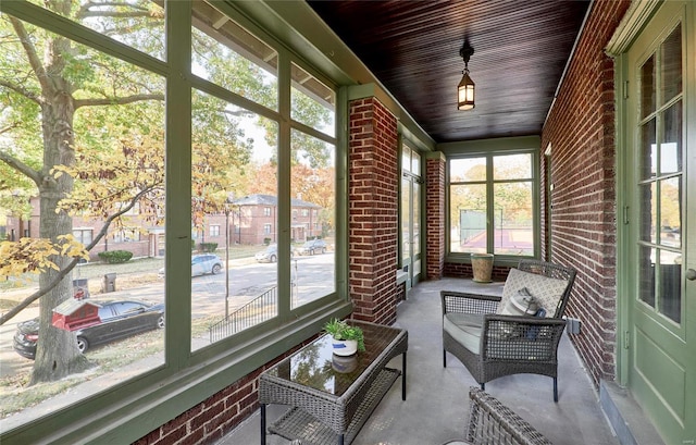 unfurnished sunroom with wooden ceiling