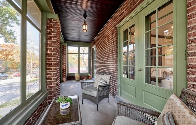 unfurnished sunroom featuring wood ceiling