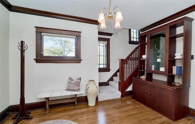 interior space featuring ornamental molding, hardwood / wood-style floors, and an inviting chandelier