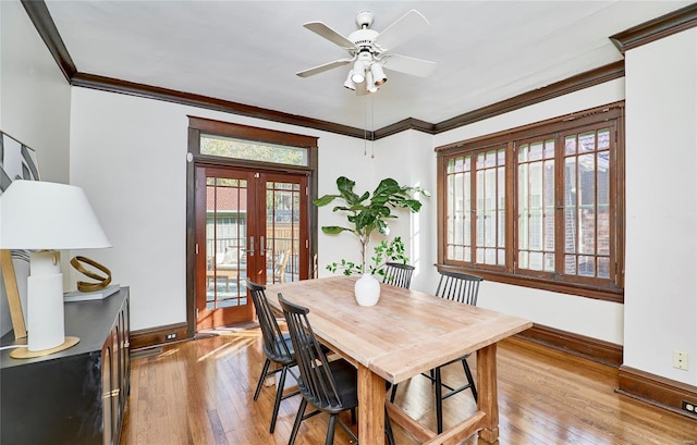 dining room featuring light hardwood / wood-style floors, french doors, crown molding, and ceiling fan