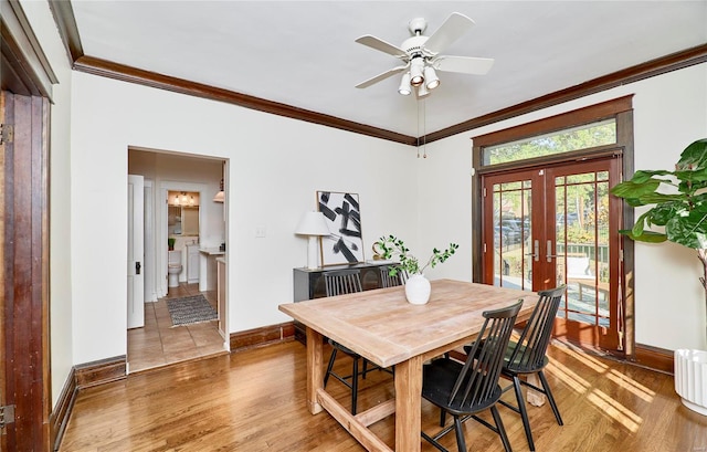 dining space featuring french doors, crown molding, wood-type flooring, and ceiling fan