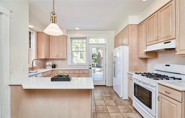 kitchen with white appliances, tasteful backsplash, light brown cabinetry, kitchen peninsula, and pendant lighting