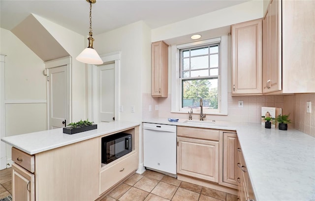 kitchen with light brown cabinets, black microwave, dishwasher, pendant lighting, and sink