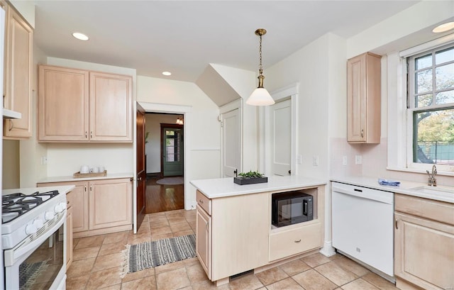 kitchen featuring light brown cabinets, sink, light hardwood / wood-style floors, decorative light fixtures, and white appliances