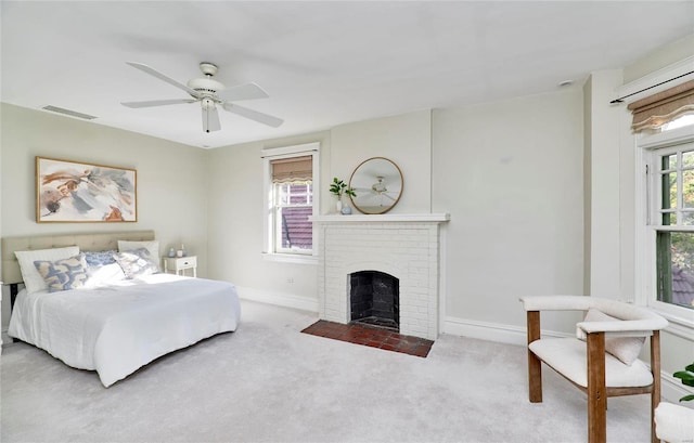 carpeted bedroom featuring ceiling fan and a brick fireplace