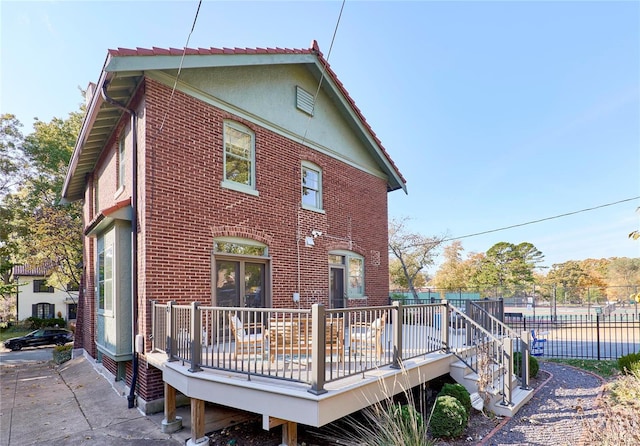 rear view of property with a swimming pool side deck