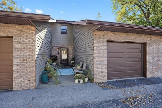 view of exterior entry with a garage