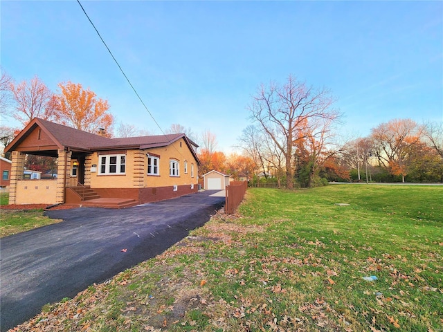 view of home's exterior featuring an outbuilding, a yard, and a garage