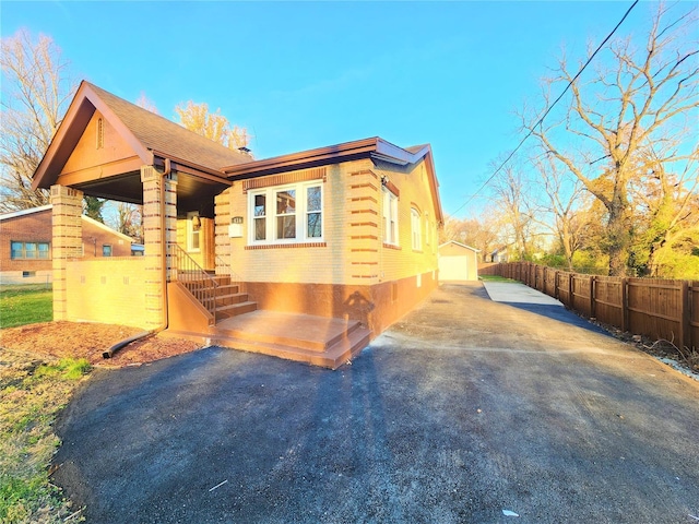 view of front of property featuring a garage and an outdoor structure