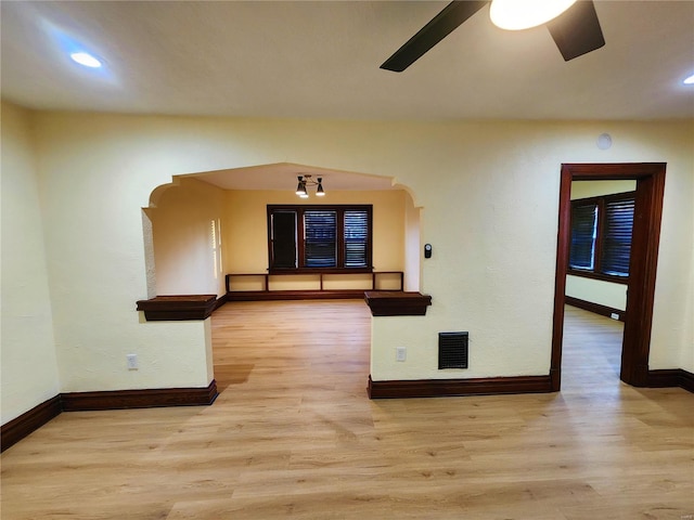 unfurnished room with ceiling fan and light wood-type flooring