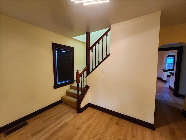 staircase with wood-type flooring