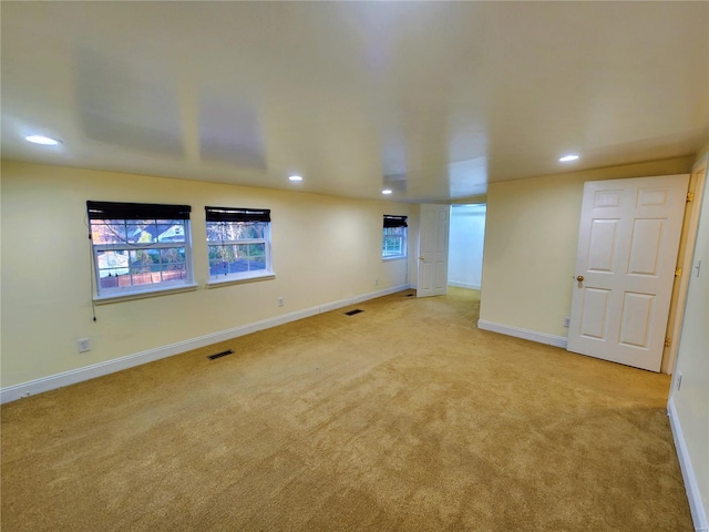 basement featuring light colored carpet