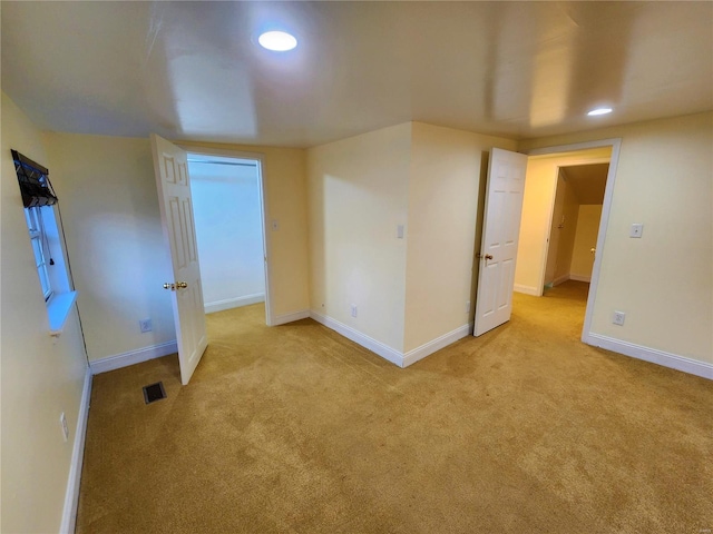 spare room with light carpet