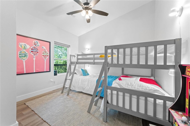 bedroom with vaulted ceiling, hardwood / wood-style flooring, and ceiling fan