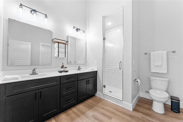 bathroom featuring vanity, hardwood / wood-style floors, toilet, and walk in shower