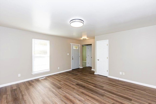 unfurnished room featuring dark wood-type flooring