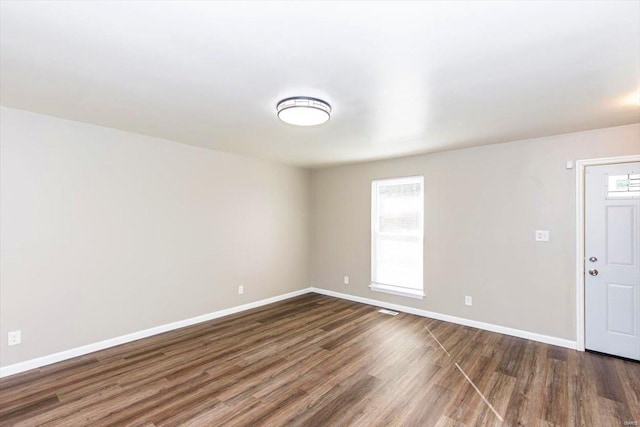 empty room featuring dark hardwood / wood-style flooring