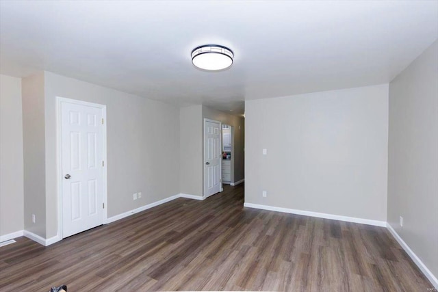 empty room featuring dark wood-type flooring