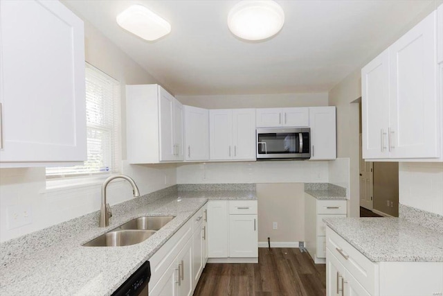 kitchen featuring dishwasher, dark hardwood / wood-style floors, sink, white cabinets, and light stone counters