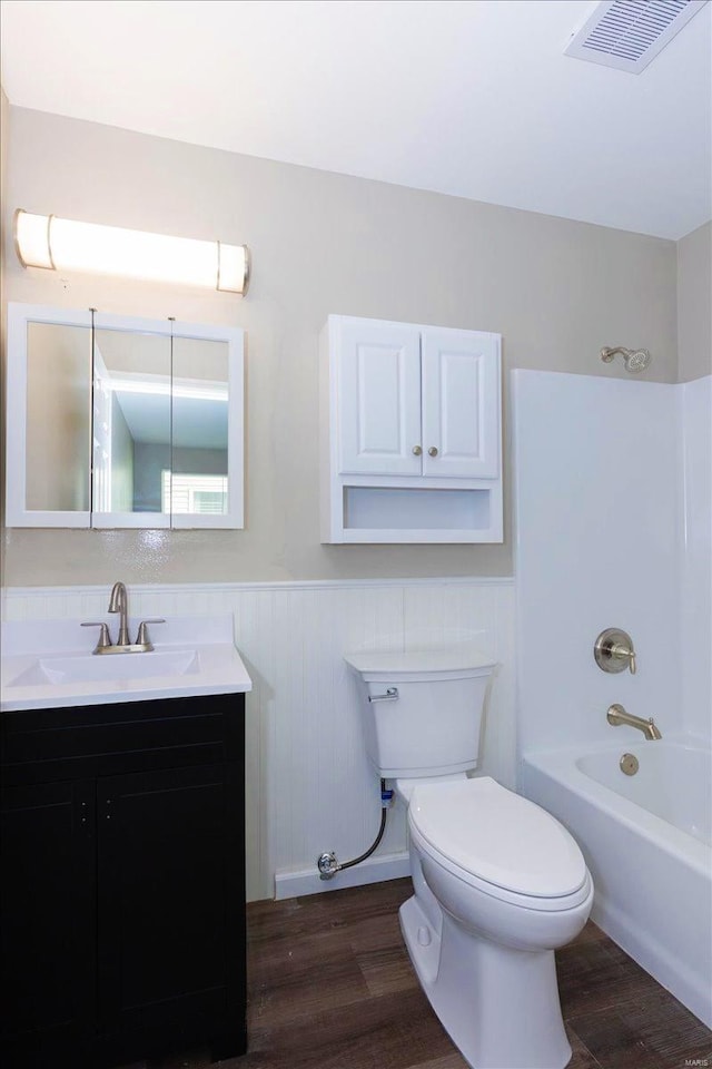 full bathroom with vanity, toilet, hardwood / wood-style flooring, and shower / bathing tub combination