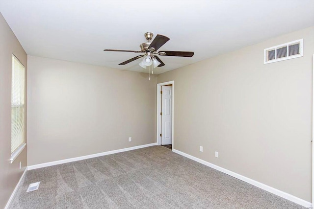 carpeted empty room featuring ceiling fan and a healthy amount of sunlight