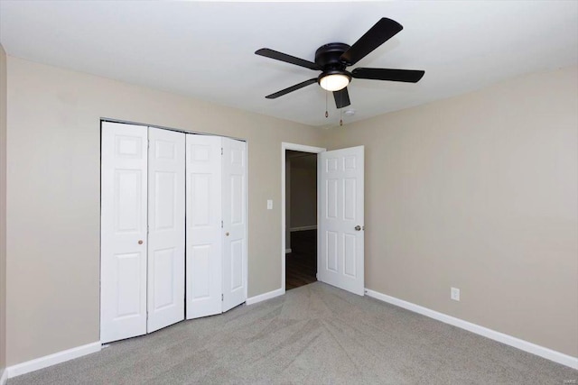 unfurnished bedroom with a closet, ceiling fan, and light carpet