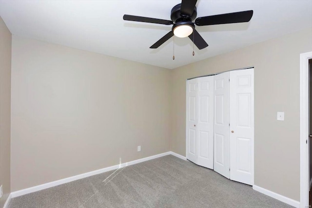 unfurnished bedroom featuring a closet, ceiling fan, and light carpet