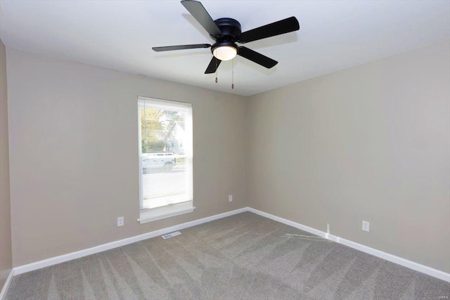 carpeted spare room with ceiling fan