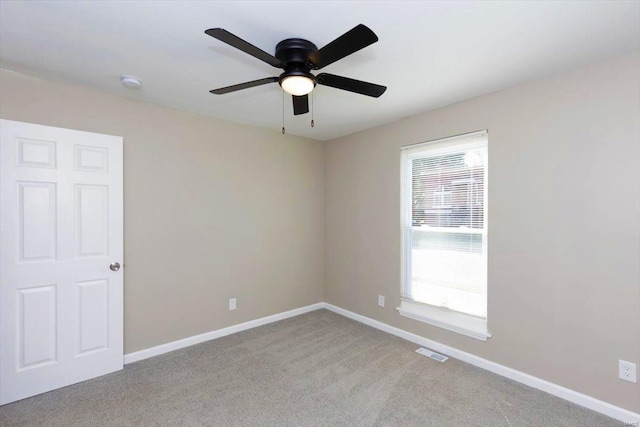 empty room featuring light carpet and ceiling fan