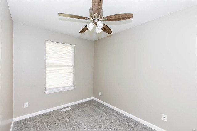 spare room with light colored carpet and ceiling fan