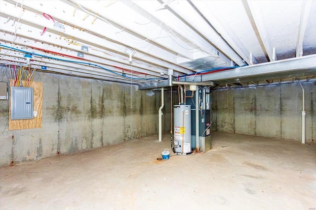 basement featuring gas water heater, electric panel, and heating unit