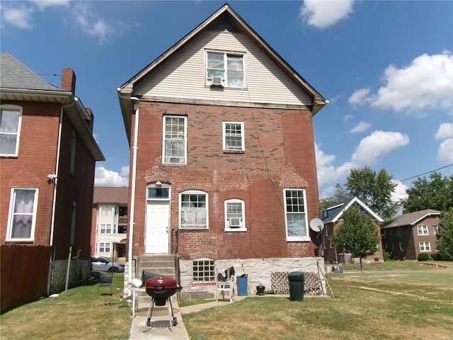 back of property with a lawn and cooling unit