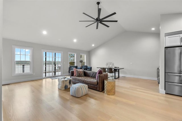 living room featuring lofted ceiling, light hardwood / wood-style floors, and ceiling fan