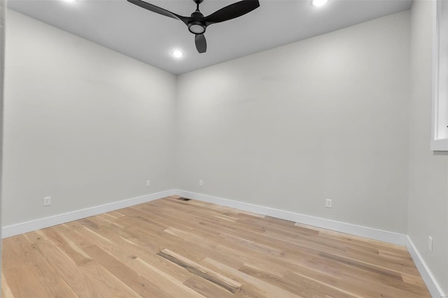 spare room featuring wood-type flooring and ceiling fan