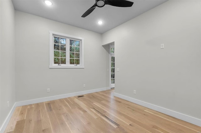 spare room featuring light hardwood / wood-style flooring and ceiling fan