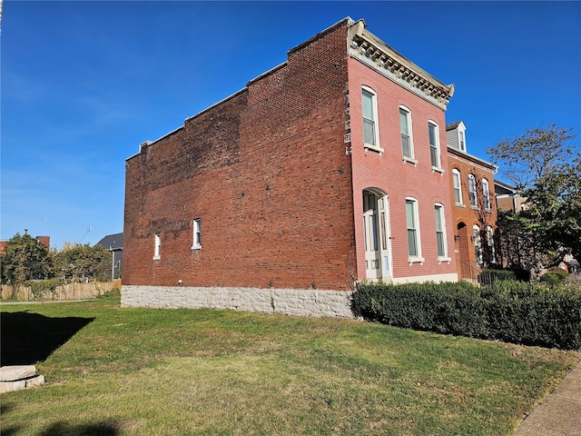 view of side of home featuring a yard