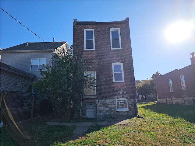 back of house with a lawn