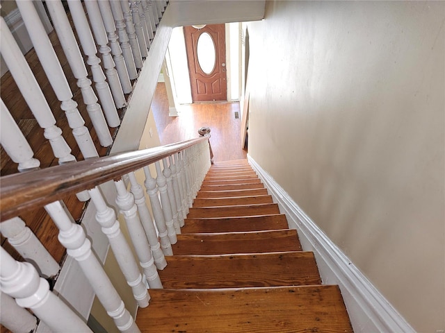 stairs featuring hardwood / wood-style flooring