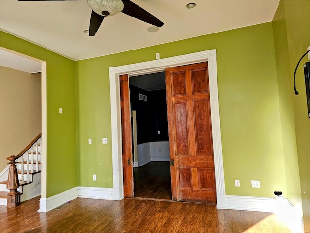 spare room with ceiling fan and dark hardwood / wood-style floors