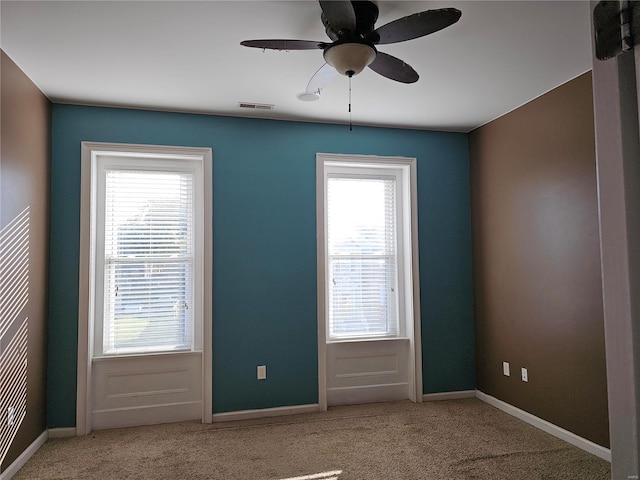 carpeted empty room with ceiling fan